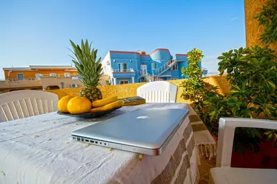 a laptop sitting on a table with fruit on it at Apartments Dalila in Ulcinj