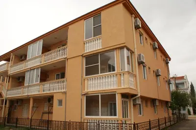 an apartment building with balconies and a fence at Apartments Dalila in Ulcinj