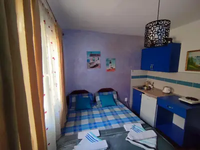 a small room with a bed and a sink at Apartments Blago Sutomore in Sutomore