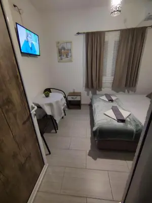 a hospital room with a bed and a table at Apartments Blago Sutomore in Sutomore