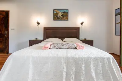 a bedroom with a bed with a white bedspread at Apartments Miona in Virpazar