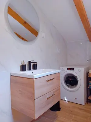 a bathroom with a sink and a washing machine at Apartment Dora in Kotor