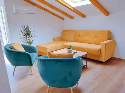 a living room with a couch and two chairs and a table at Apartment Dora in Kotor