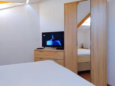 a bedroom with a bed and a tv and a mirror at Apartment Dora in Kotor