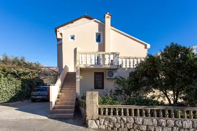 a white house with stairs and a fence at Guest House Lotos in Becici