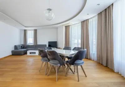 a living room with a table and chairs and a couch at Montesun Apartments in Budva
