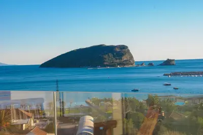 a view of the ocean and an island at Montesun Apartments in Budva
