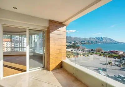 a large balcony with a view of the water at Montesun Apartments in Budva