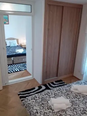 a bedroom with a large mirror and a bed at Apartmani Steni in Sveti Stefan