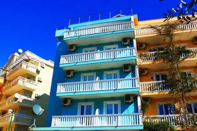 a tall blue building with white balconies on it at Stojko Rafailovici in Rafailovici