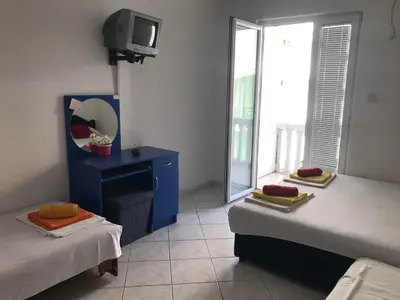a room with two beds and a tv in it at Stojko Rafailovici in Rafailovici