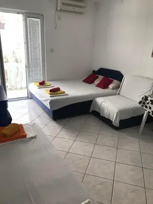 a bedroom with two beds and a couch at Stojko Rafailovici in Rafailovici