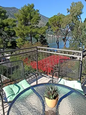 a table and chairs with a view of the water at Apartments Vojvoda in Kotor
