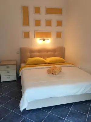 a bedroom with a bed with two towels on it at Apartments Vojvoda in Kotor