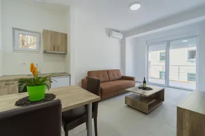 a living room with a table and a couch at GREJM Lux Family Apartments in Petrovac na Moru