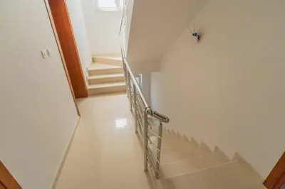 a staircase in a house with a metal handrail at GREJM Lux Family Apartments in Petrovac na Moru
