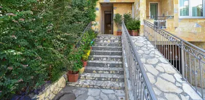 a set of stairs leading to a house with a door at Apartment Golden Lavender in Budva