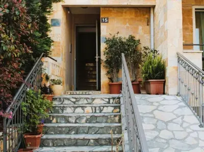 a staircase leading to a house with potted plants at Apartment Golden Lavender in Budva