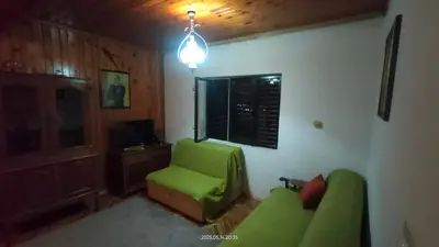 a living room with a green couch and a chair at Holiday house Nebojsa in Bar