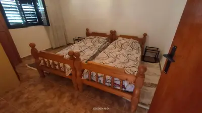 a bedroom with a wooden bed in a room at Holiday house Nebojsa in Bar