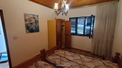 a bedroom with a bed and a window at Holiday house Nebojsa in Bar