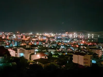 a view of a city at night with lights at Holiday house Nebojsa in Bar