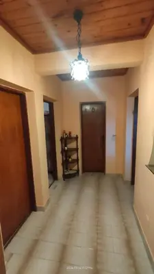 an empty room with a hallway with a chandelier at Holiday house Nebojsa in Bar