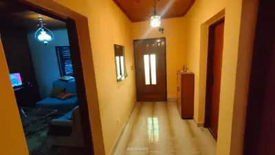 a hallway of a room with a door and a couch at Holiday house Nebojsa in Bar