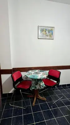 a table and two chairs in a room at Apartments Holiday in Budva
