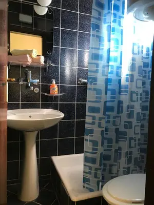 a bathroom with a sink and a toilet and a mirror at Apartments Holiday in Budva