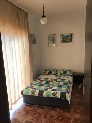 a bedroom with a bed and a window at Apartments Holiday in Budva