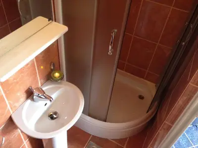 a bathroom with a shower and a sink and a toilet at Apartments Holiday in Budva