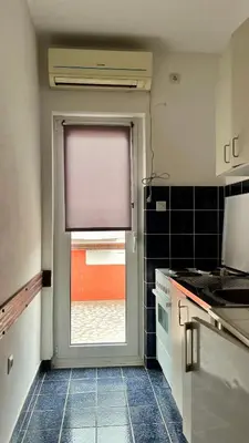 a kitchen with a door with a window in it at Apartments Holiday in Budva