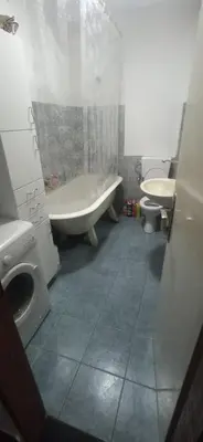 a bathroom with a tub and a sink and a toilet at Hostel Olea in Podgorica