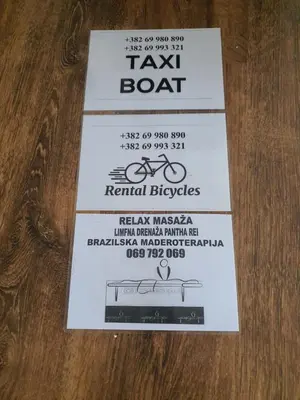 a ticket for a taxi boat on a table at Apartments Hillside in Ulcinj