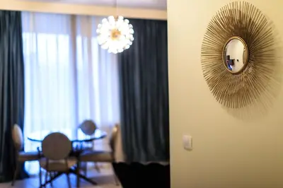 a mirror on the wall of a room with chairs at Royal Montesun Apartments in Budva