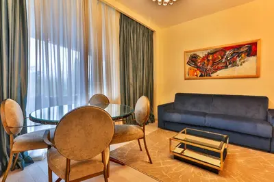 a living room with a table and a couch at Royal Montesun Apartments in Budva