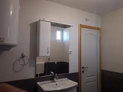 a bathroom with a sink and a mirror at Pensions Airport in Podgorica