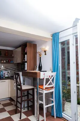 a kitchen with a table and chairs in a room at Apartmani Kamena Ruža in Budva