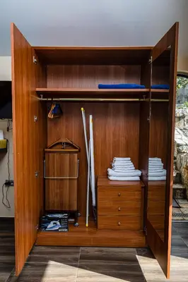 a wooden cabinet with two shelves and a drawer at Apartmani Kamena Ruža in Budva