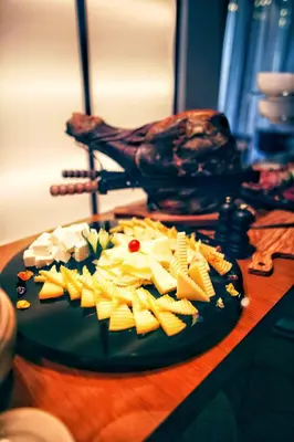 a plate of cheese and other foods on a table at Hotel Kalos in Budva
