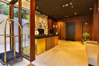 a lobby with a desk and a chair in a room at Hotel Kalos in Budva
