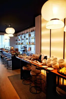 a restaurant with a bar with a lot of dishes at Hotel Kalos in Budva