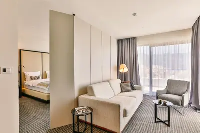 a hotel room with a couch and a bed at Hotel Kalos in Budva
