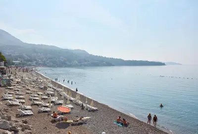 a beach with a bunch of people on it at Apartments Wild Beauty in Sutomore