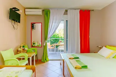 a bedroom with two beds and a table and chairs at Apartments Wild Beauty in Sutomore