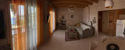 a living room with a couch and a refrigerator at SeaStar Eco Villa in Utjeha