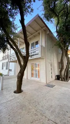 a white house with a tree in front of it at SeaStar Eco Villa in Utjeha