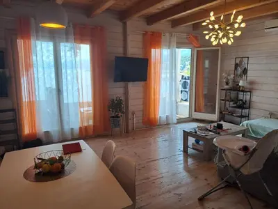 a living room with a table and chairs and a dining room at SeaStar Eco Villa in Utjeha