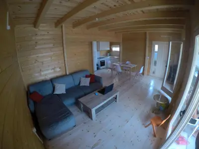 a living room with a blue couch and a table at SeaStar Eco Villa in Utjeha